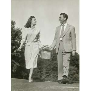  Young Couple Walking in Park, Carrying Basket and Looking 