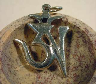 pendant presented inside a marble bowl