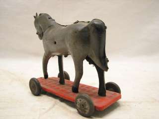 nice hand painted tin hobby horse on wheels. Looks like it had a 