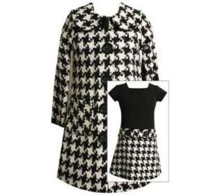   with a dressy coat that features big black buttons and pockets on