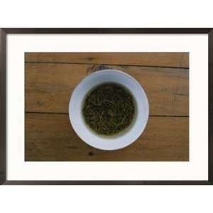  Tea leaves steep in a cup of hot water for green tea 