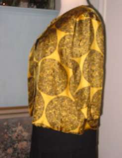  is for a Stunning, Gold Silk Jacket with a Beautiful, Round, Black 