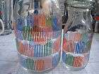 MILK BOTTLES   1 LARGE & 1 SMALL USED BOTTLES WITH ATTACHED LIDS 